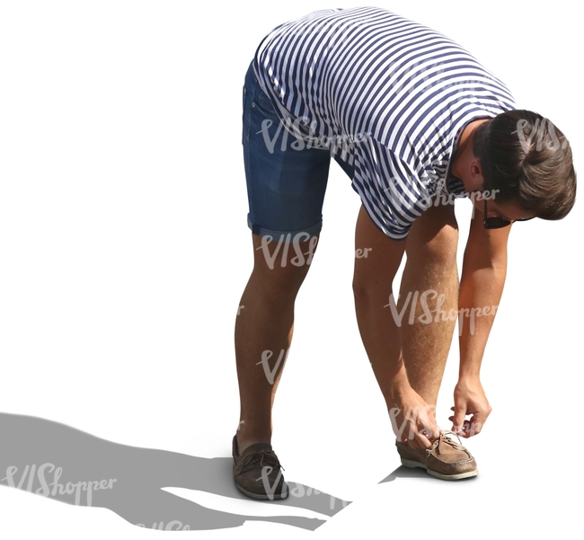 man in a striped shirt tying his shoelaces
