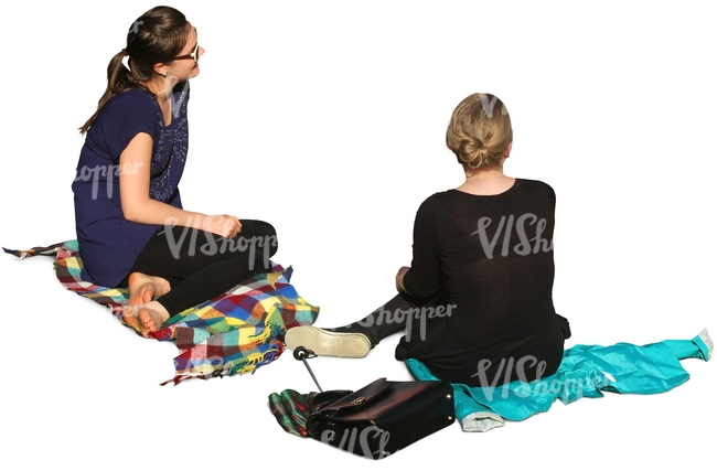 two women sitting on the ground