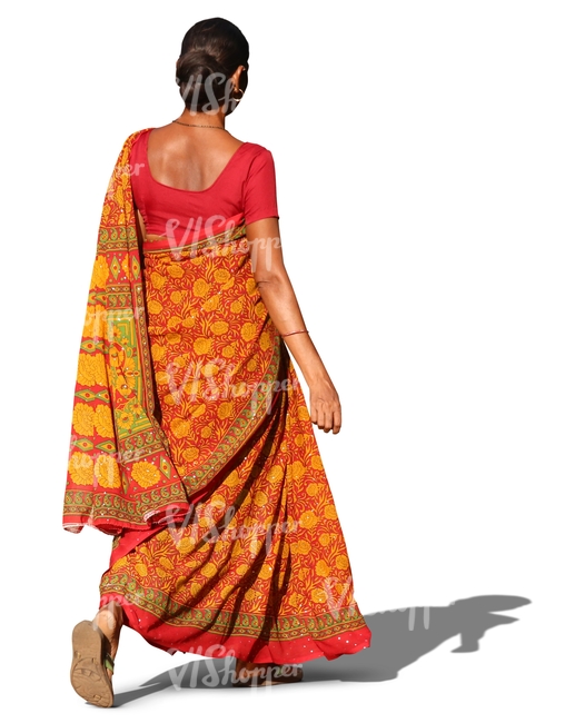 indian woman in a traditional orange sari walking