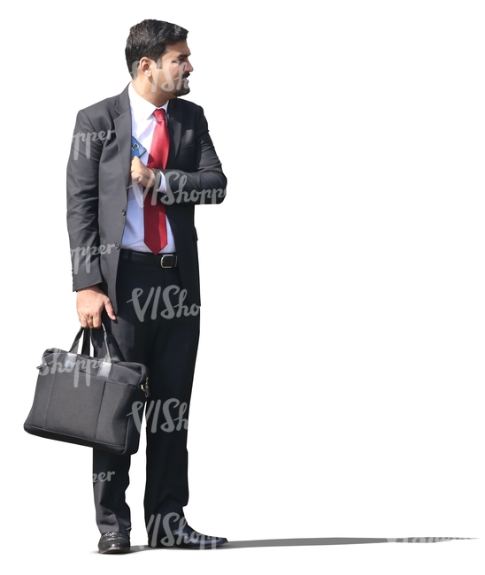 indian businessman in a suit standing with a bag in his hand