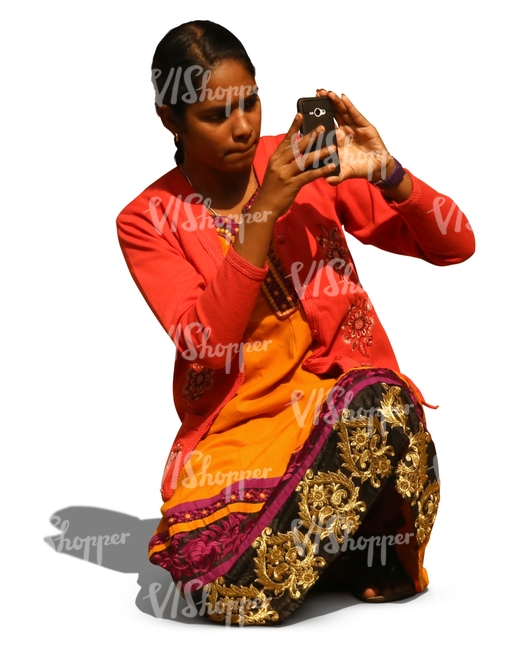 indian woman kneeling and taking a picture