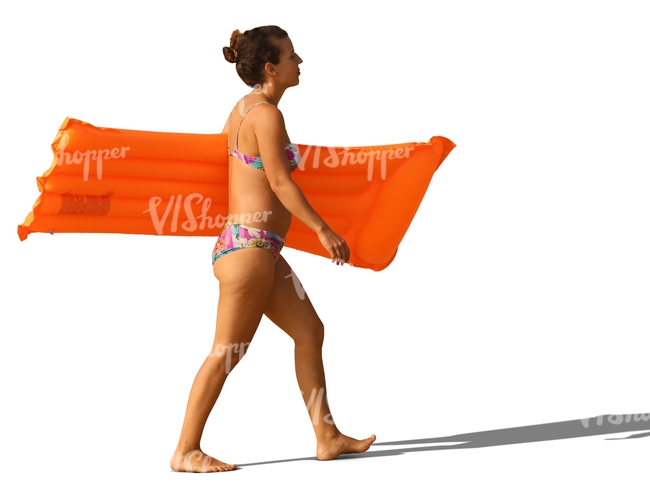 woman in a bikini walking with a floatie