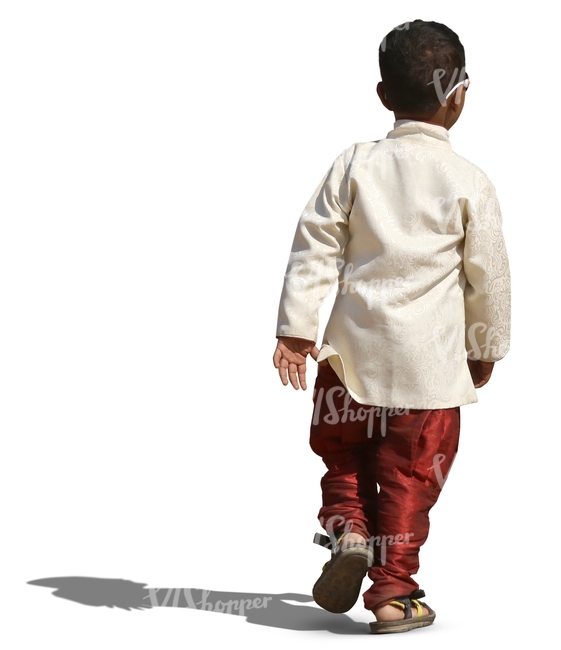 small hindu boy in a fancy costume walking