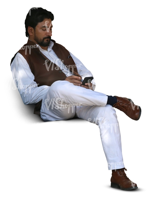 indian man sitting and looking at his phone