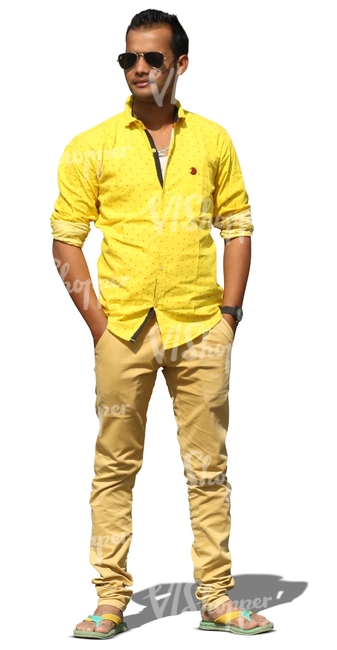 indian man in a yellow shirt standing