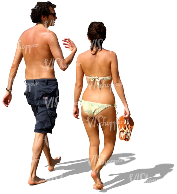 man and woman walking barefoot on the beach and talking