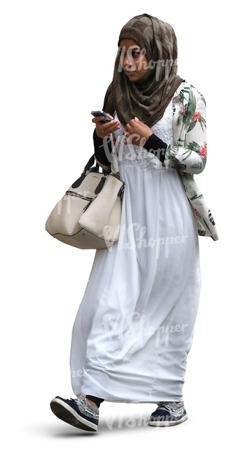 black muslim woman walking with a phone in her hand