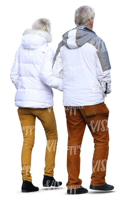 elderly man and woman wearing winter jackets walking