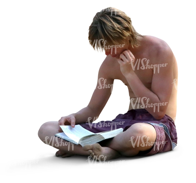 man sitting on the beach and reading