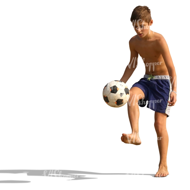 boy playing football on the beach