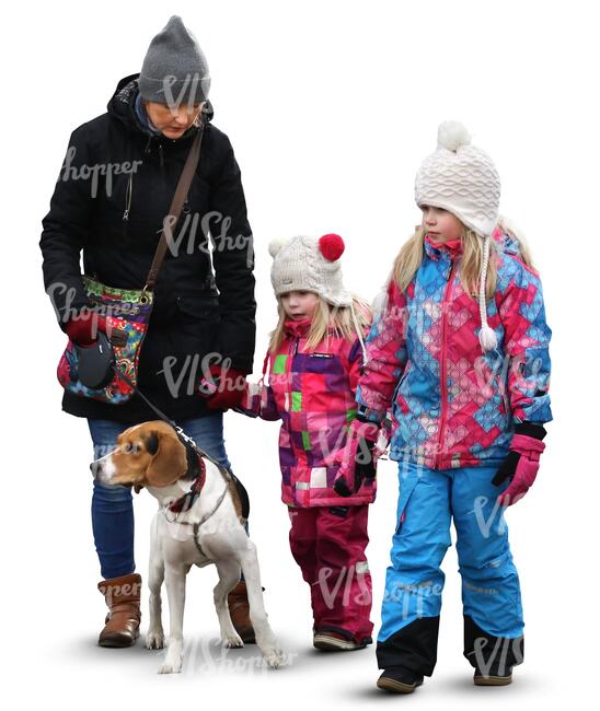 family with two children and a dog walking in wintertime