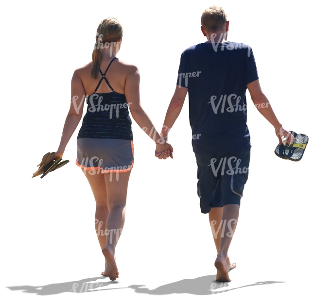 couple walking hand in hand on the beach