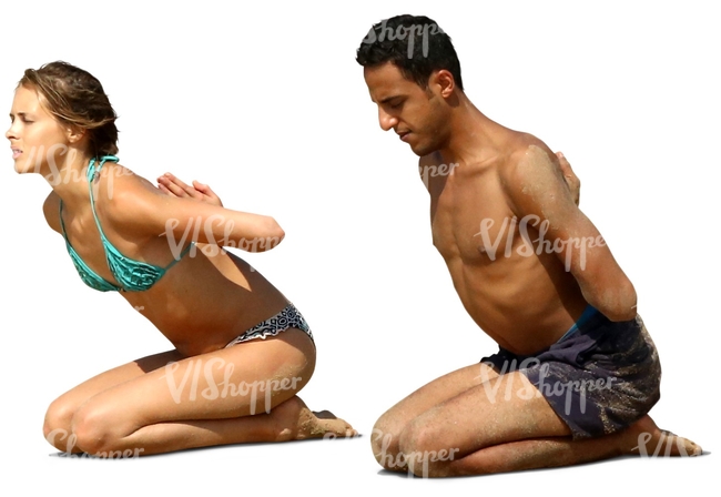 man and woman doing a yoga exercise on the beach