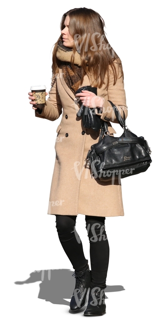 woman walking with a coffee cup in her hand