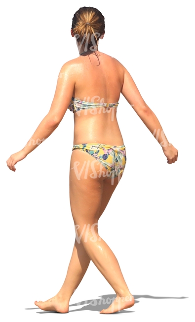 woman in a bikini walking on the beach