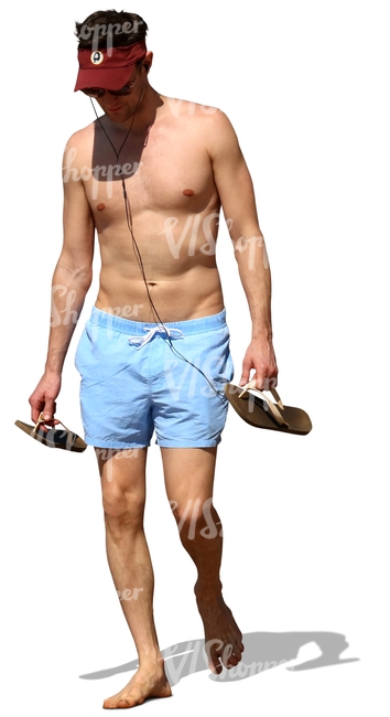 man walking barefoot on the beach and listening to music