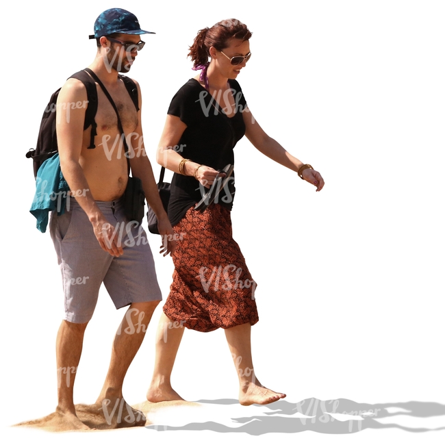 couple walking barefoot on a sandy beach