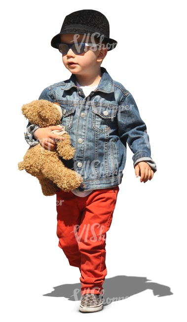 boy walking with a teddy bear under his arm