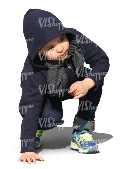 little boy squatting and looking up