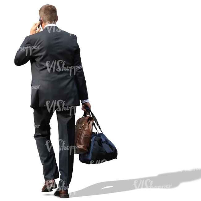 businessman carrying two bags and talking on the phone