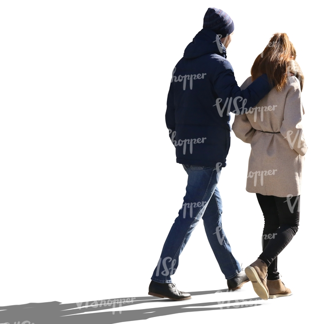 backlit couple walking with the mans arm around the woman