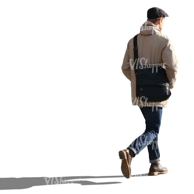 backlit man walking hands in his pocket