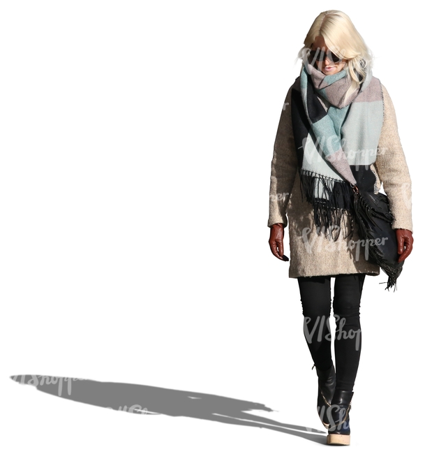 woman wearing a large scarf and coat walking