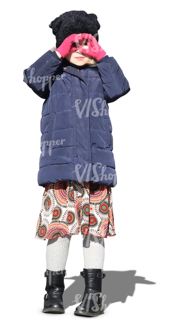 little girl wearing a winter jacket standing in the sunlight
