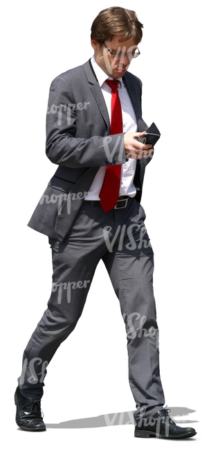 businessman walking and looking at his phone