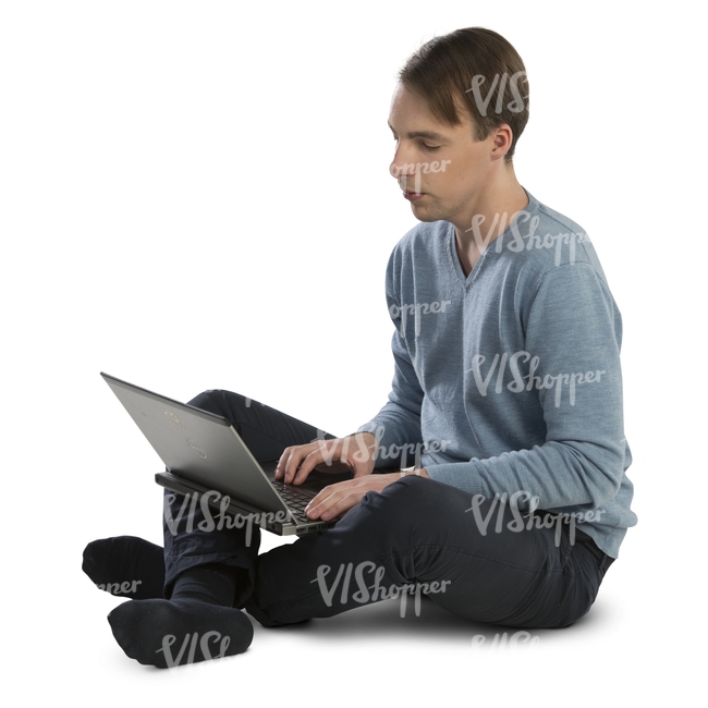 man sitting on the floor and working with a laptop