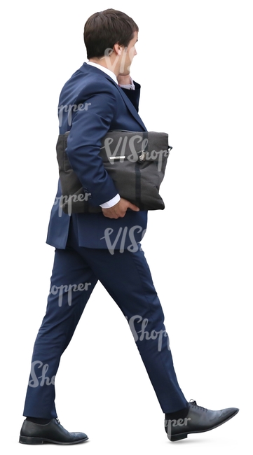 businessman with a briefcase walking and talking on the phone