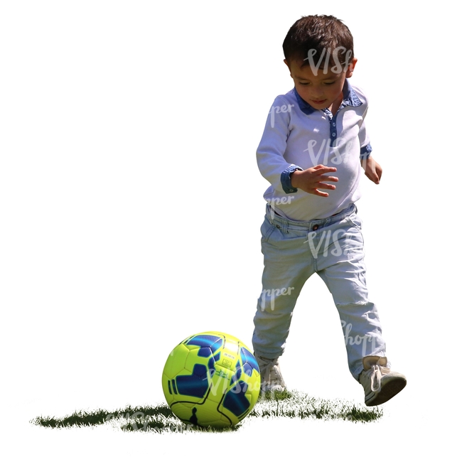 backlit boy playing football in the park