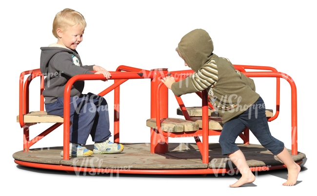 two boys playing on a carousel