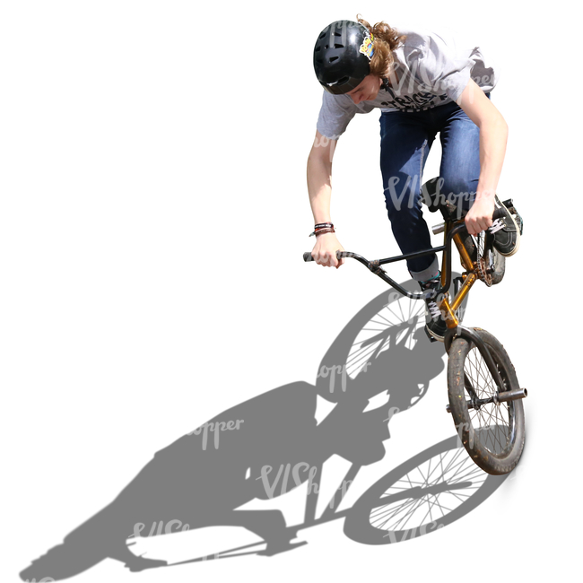 teenage boy riding a bmx in a skatepark