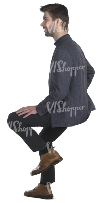man in a suit sitting on a bar stool