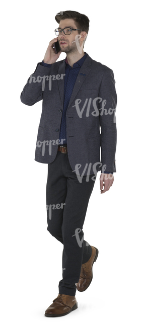 modern businessman walking and talking on the phone 