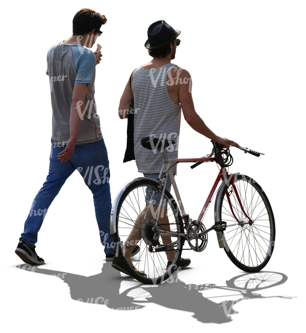 two backlit men walking and one has a bike