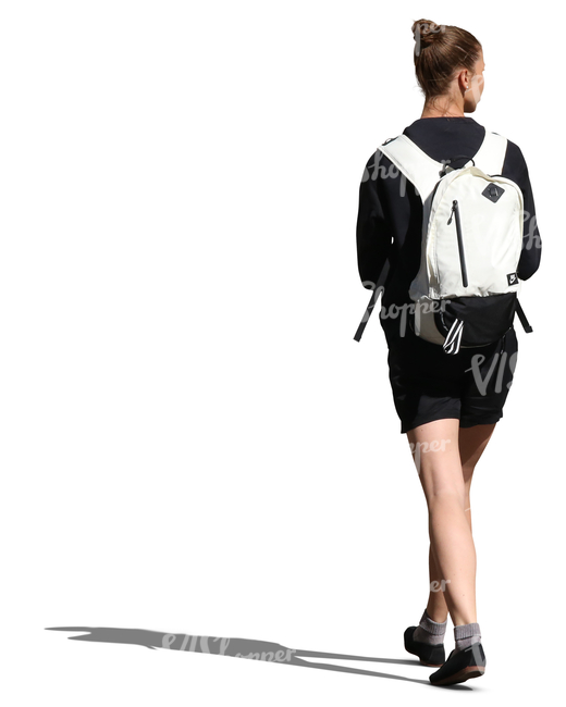 woman with a white backpack walking in the sunlight