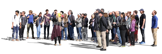 big group of people standing and listening to their guide