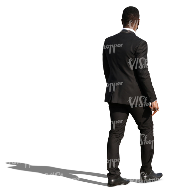 african man in a black formal suit walking