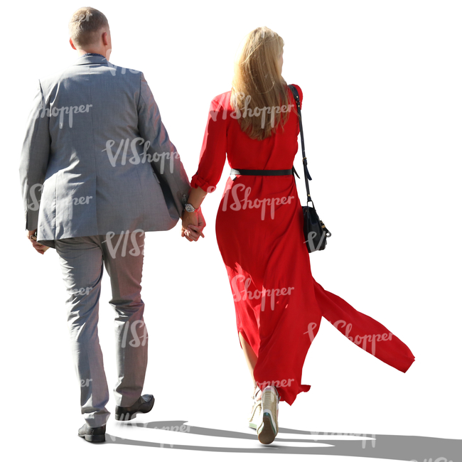 backlit couple in formal outfits walking hand in hand