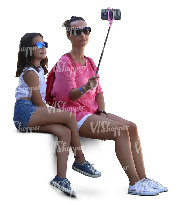 mother and daughter sitting and taking a selfie together