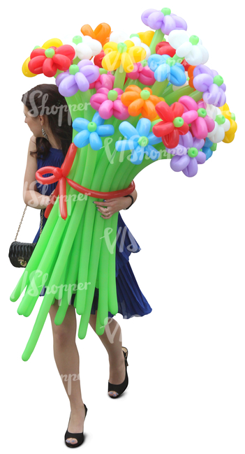 woman in a blue dress walking and carrying balloon flowers