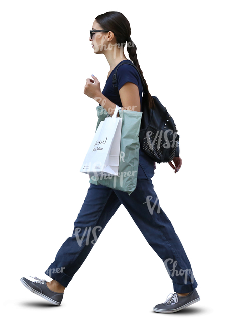 stylish woman with shopping bags walking in ambient light