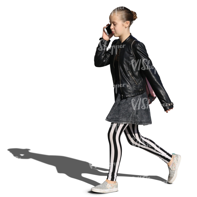 young girl in striped leggings walking and talking on the phone