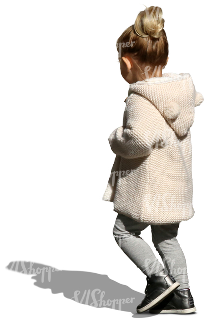 small girl with a beige cardigan walking on the street