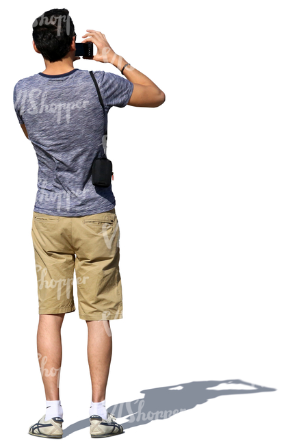 man in shorts standing and taking a picture
