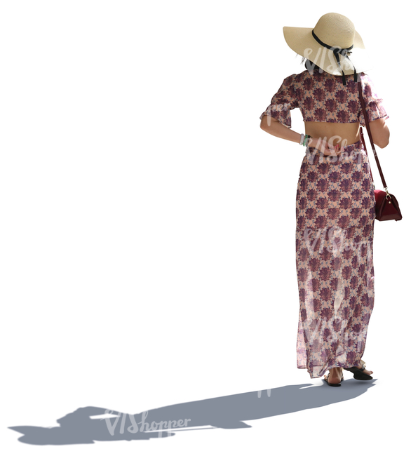 backlit asian woman in a summer dress walking