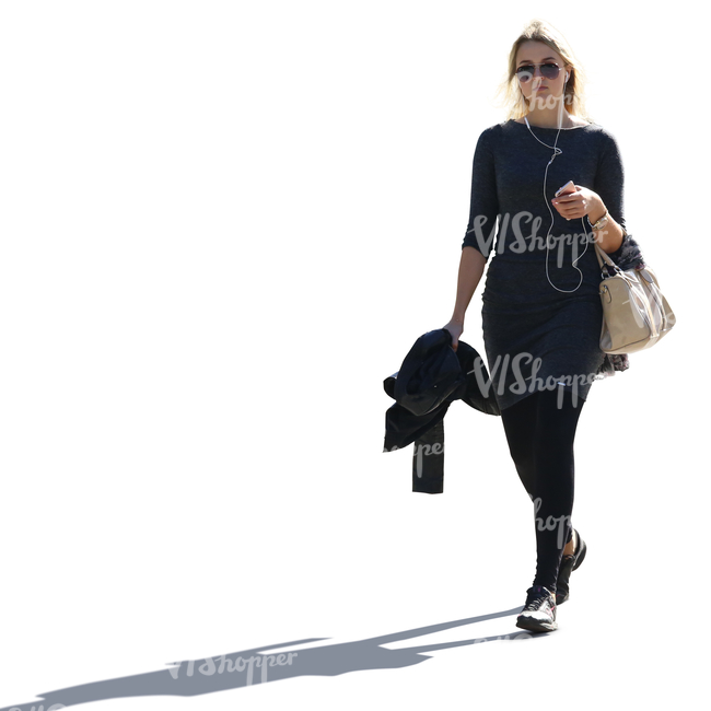 backlit blond woman in black clothes walking and listening to music