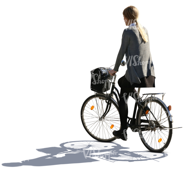 backlit woman riding a bike
